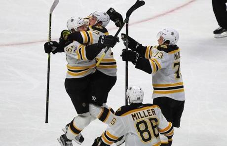The Bruins? Sean Kuraly(left) jumped into the arms of Frank Vatrano after his winning second overtime goal. 
